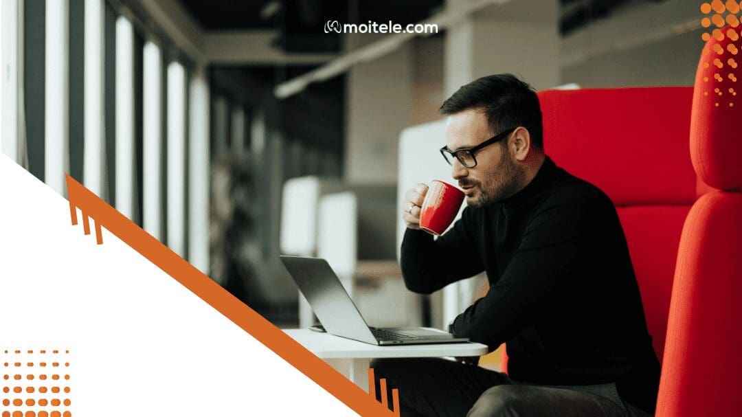 man sitting and working on laptop